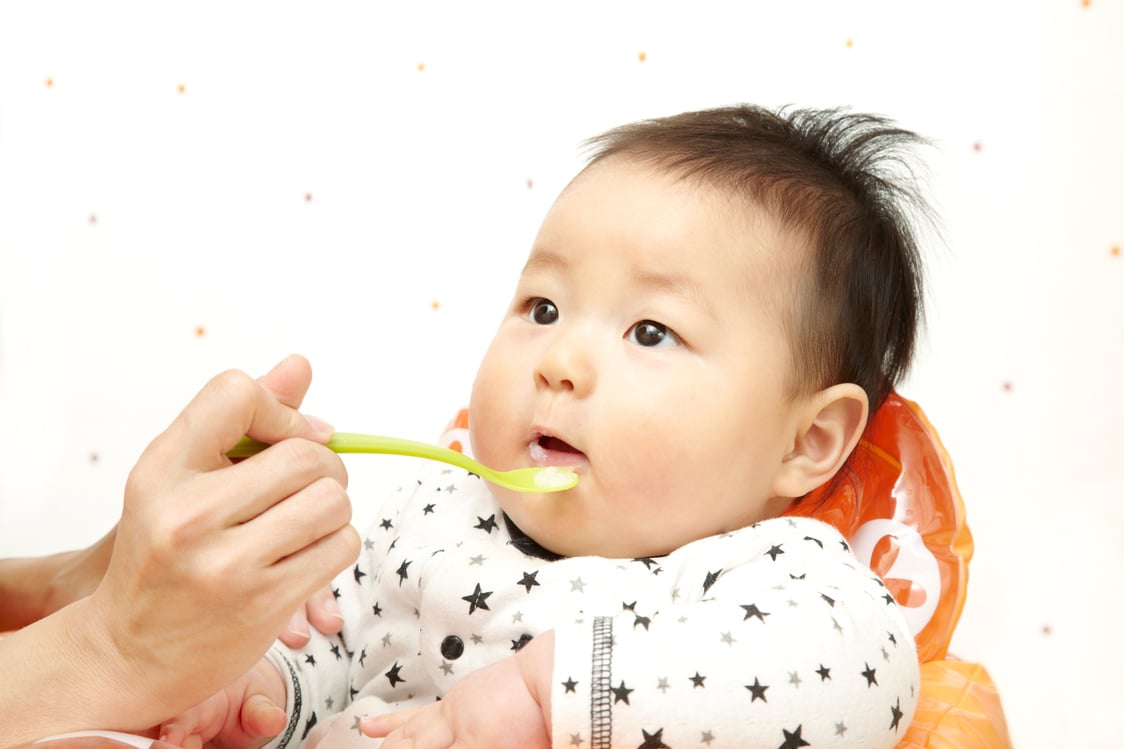 Baby eating baby food Japanese boy